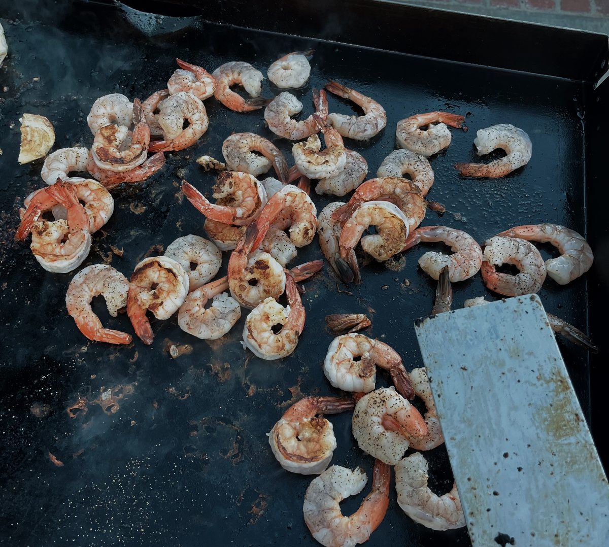 Shrimp sizzling on the flat top grill